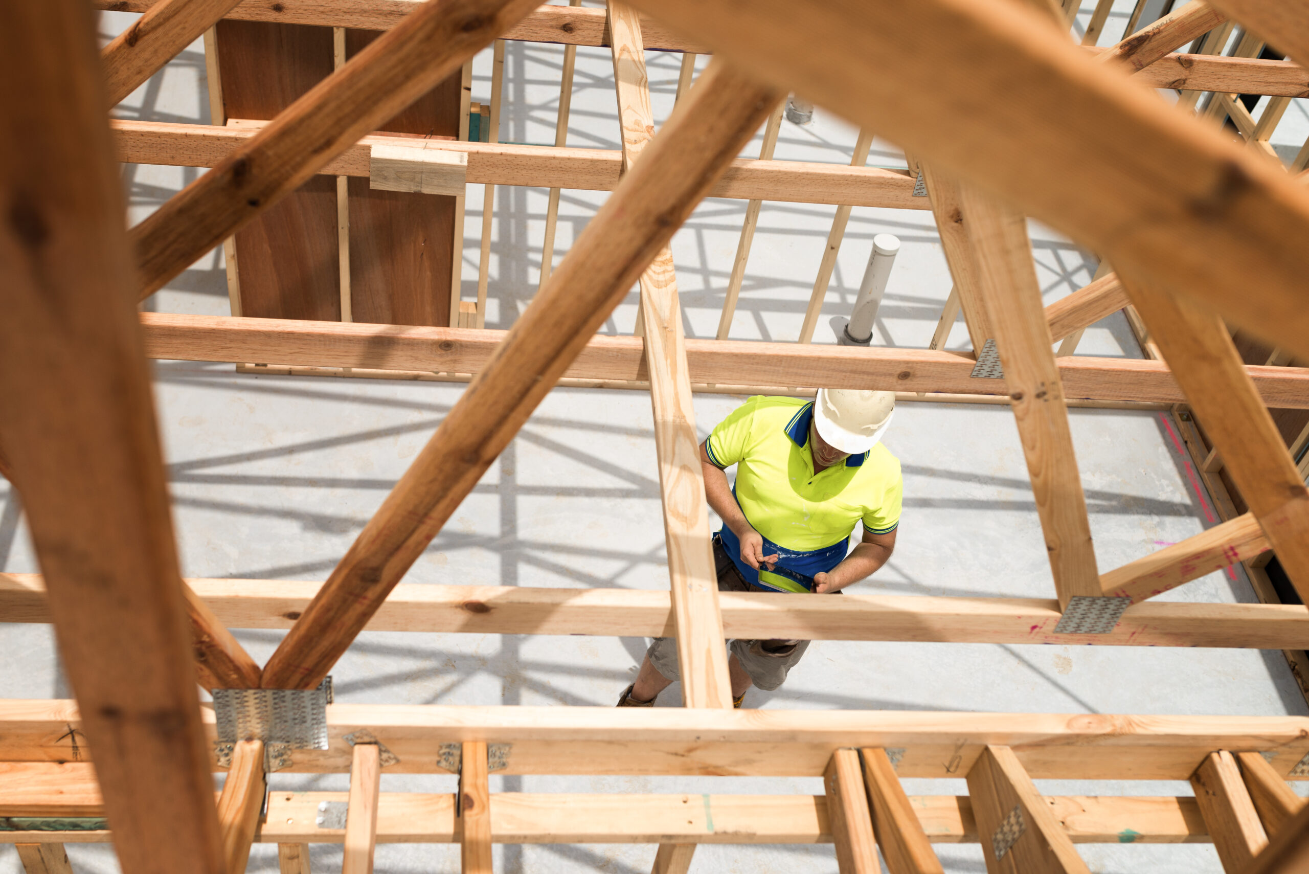 Builder checking plan on digital tablet